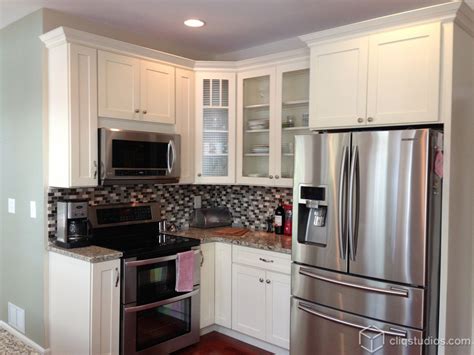 Mount the crown molding to the cabinet using the brad nailer. Cute white shaker kitchen with an island with barstool ...