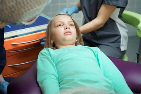 Little Scared Girl Sitting In Chair In Dentist Doctor Office Kidchild