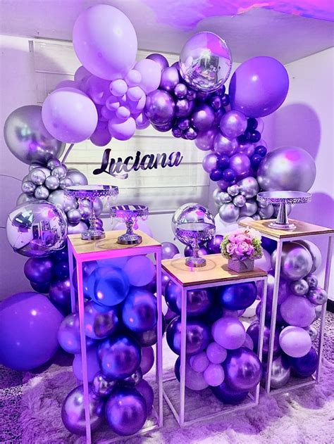 Purple And Silver Balloons Are On Display At An Event