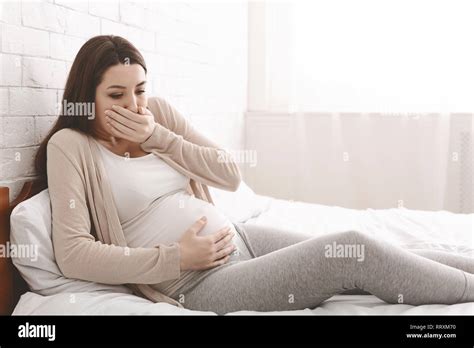 Pregnant Woman Suffering From Morning Nausea In Bed Stock Photo Alamy
