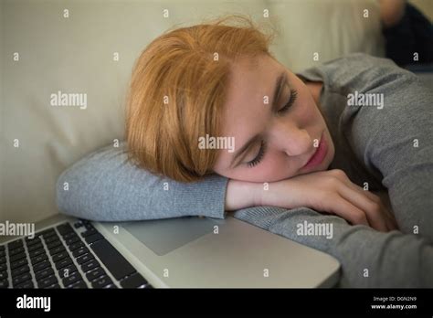 Redhead Sleeping On The Sofa With Her Laptop Stock Photo Alamy
