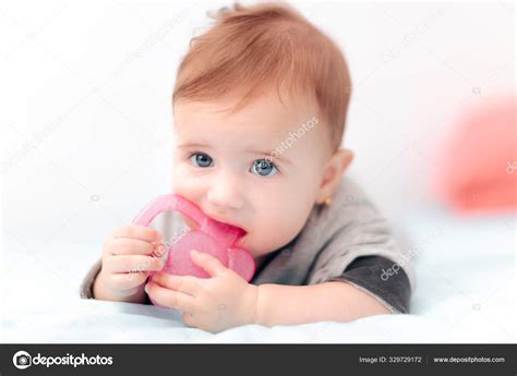 Cute Baby Biting Calming Teething Toy Stock Photo By ©nicoletaionescu