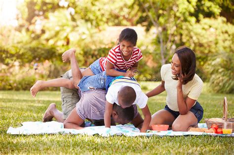 How do we know they're the hottest? Family Having Fun In Garden Together Stock Photo - Image ...