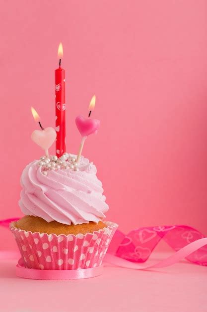Premium Photo Cupcake With Candle On Pink
