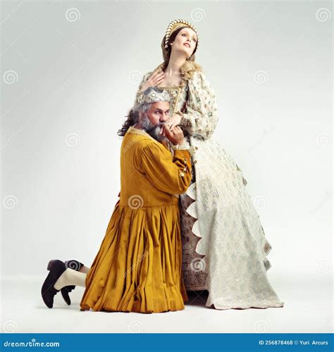 Shes the True Power Behind the Throne. Studio Shot of a King Kneeling
