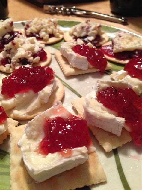 Brie Cheese Atop Plain Cracker Topped With Either Raw Thinly Sliced