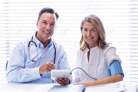Medical Professional Conducting Blood Pressure Assessment On Patient At