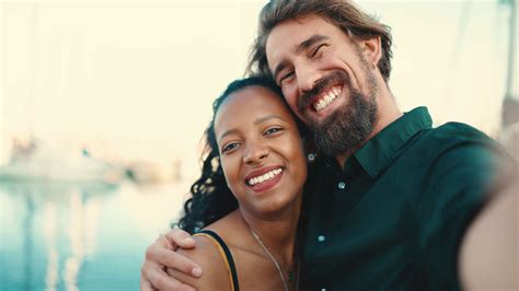 Close Up Portrait Of Happy Interracial Couple Making Selfie In The Port