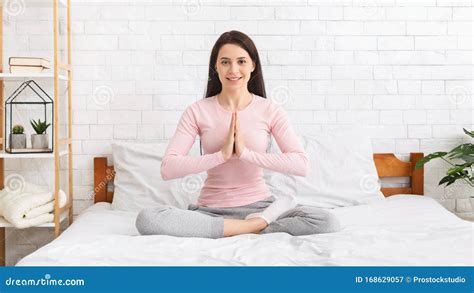 Young Woman Sitting In Lotus Position On Bed At Home Stock Image Image Of Namaste Lifestyle