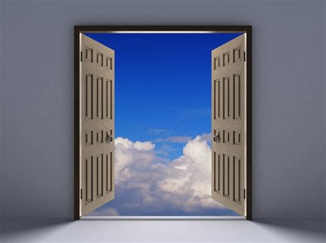 An Open Door Leading To A Bright Blue Sky With Clouds In The Background