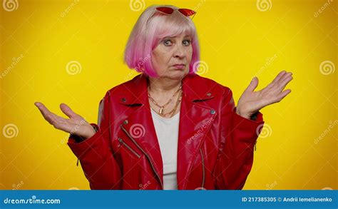 Puzzled Clueless Mature Old Granny Woman Raising Hands In Helpless