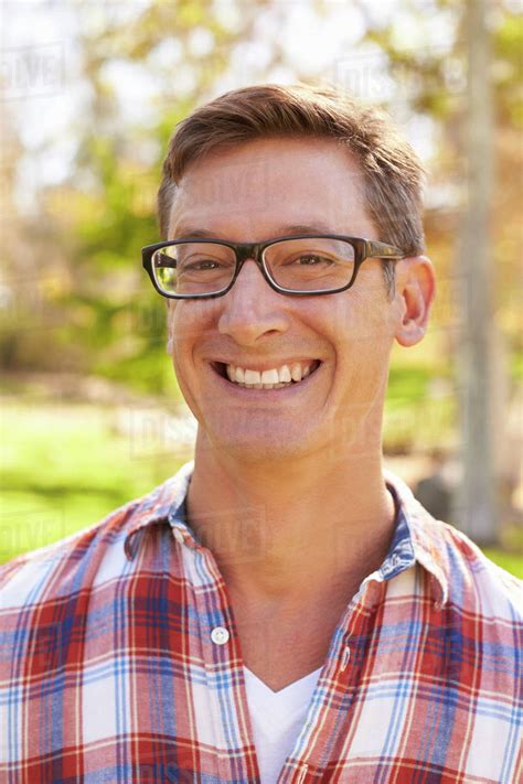 Middle Aged White Man In Glasses Smiling To Camera Vertical Stock