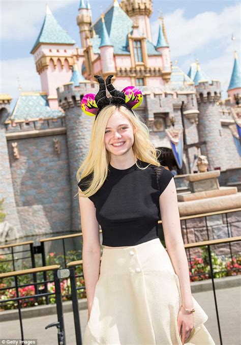 Elle Fanning Poses At Disneylands Sleeping Beauty Castle Daily Mail