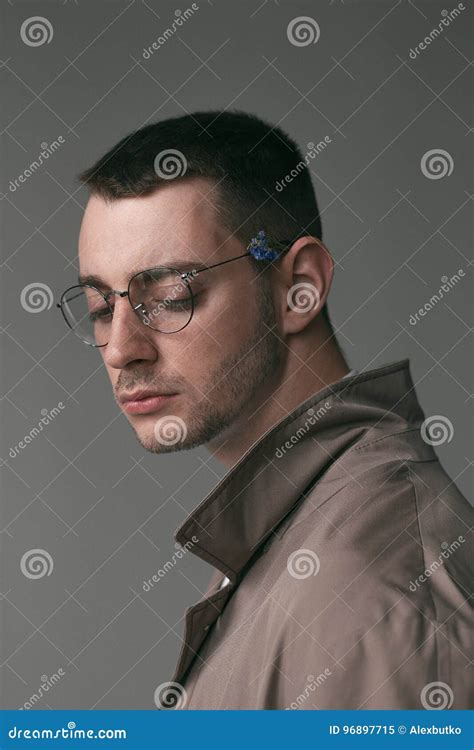 A Lonely Handsome Guy In A Raincoat And Glasses With Different Moods