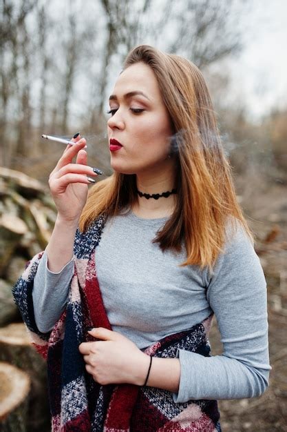 Premium Photo Young Girl Smoking Cigarette In The Forest