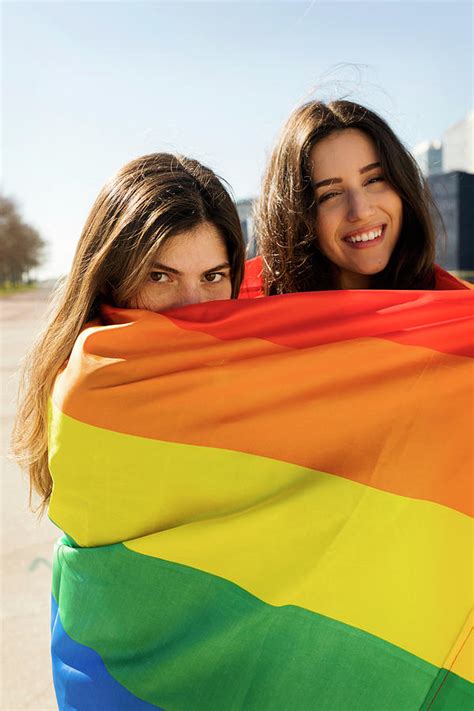 couple lesbian woman with gay pride flag in barcelona photograph by cavan images pixels