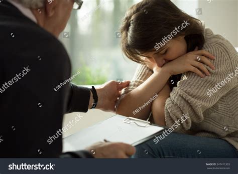 Close Up Of Psychologist Comforting His Depressed Patient Stock Photo