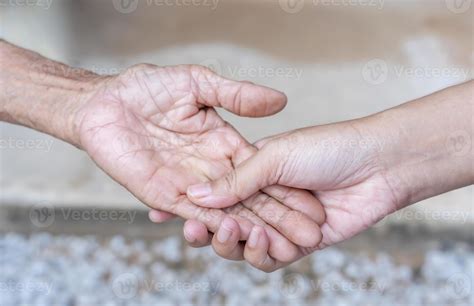 Close Up Of Old And Young Holding Hands Middle Aged Mommys Wrinkled