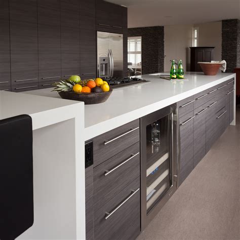 Kitchen cabinets that are not made of solid wood are usually made of some form of laminate, which is a plastic or vinyl covering that goes over a plywood or composite base. Plastic Laminate Kitchen - Oscar Granns