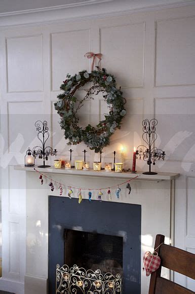 Image Wreath Above Fireplace With Lighted Tea Lights In Traditional