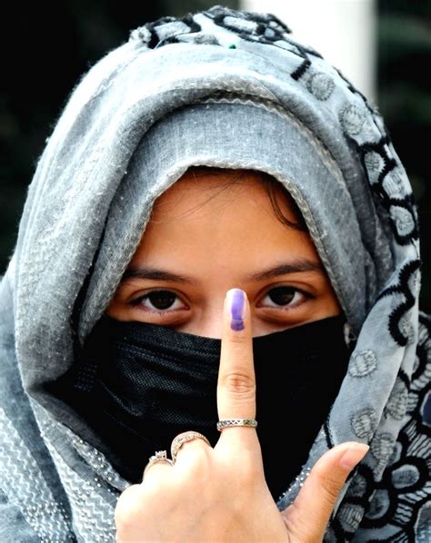a first time muslim voter isha shows her ink marked finger after casting a vote