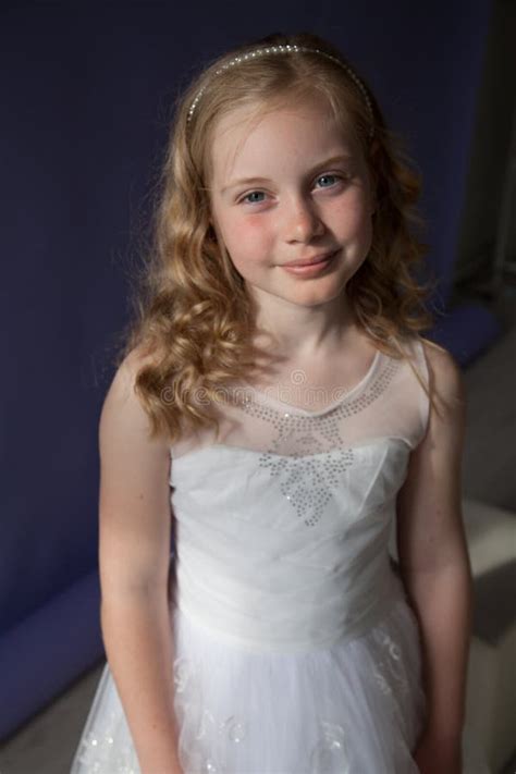 Portrait Of A Beautiful Little Blonde Girl In A White Dress Stock Image