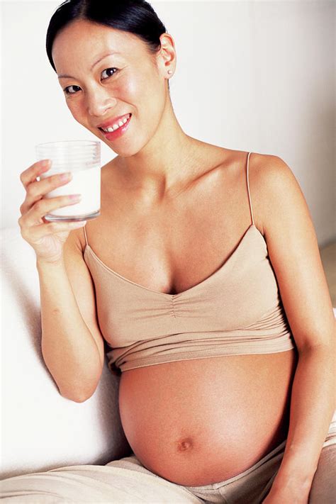 Pregnant Woman Drinking Milk Photograph By Ian Hooton Science Photo