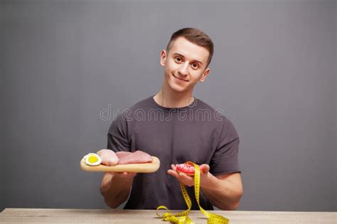 Shaped And Healthy Man Holding A Fresh Meal Board With Meat Stock Image