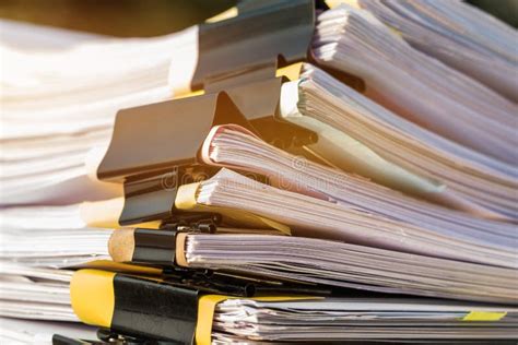 Unfinished Documents Stacks Of Paper Files On Office Desk For Report