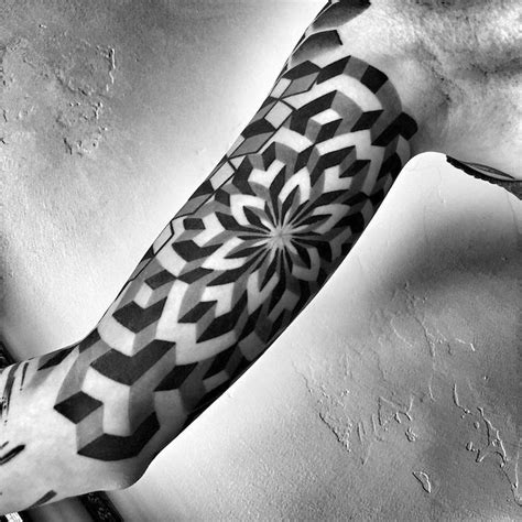 A Black And White Photo Of A Persons Arm With A Tattoo On It