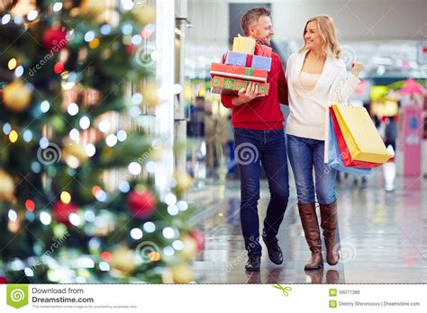 Free shipping on orders over $350. Buying Christmas gifts stock photo. Image of smiling ...
