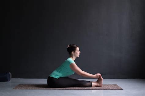 Premium Photo Woman Practicing Yoga Seated Forward Bend Pose