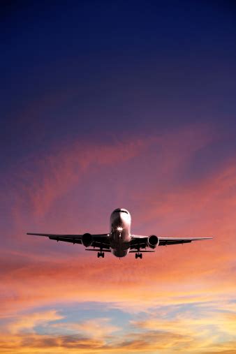 Xl Jet Airplane Landing At Sunset Stock Photo Download Image Now Istock