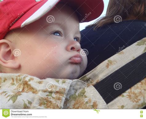 Gangster Baby Boy With Lips And Cheeks On Mother S Back Frowned Stock