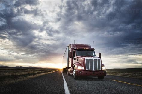 Commercial Truck On The Road At Sunset Stock Photo