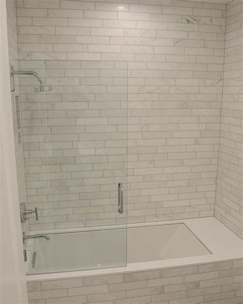 Bathtub replacement shower pans are specifically designed to fit the footprint of your existing tub making your project easy and painless. Marbel tile tub surround with gray grout in 2019 | Small ...