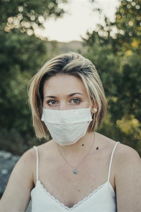 blonde masked girl enjoying the sunset during the pandemic stock image image of influence