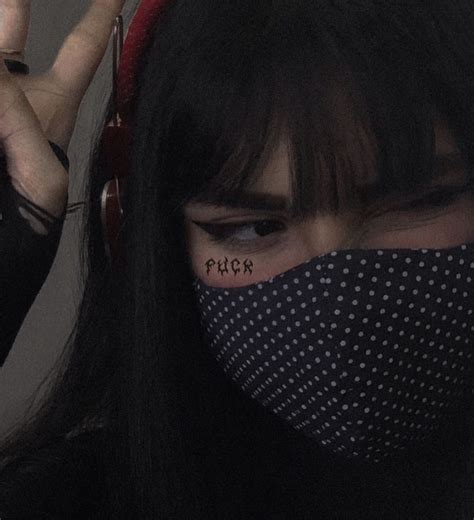 A Woman Wearing A Mask With The Word Pick Painted On Her Face And