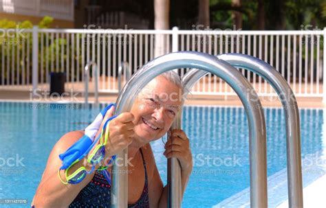 Mature Lady Comes Out Of The Pool Smiling After Physical Activity