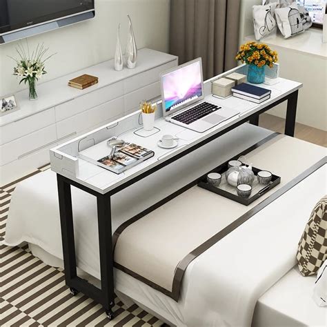 We're talking about a desk which integrates a comfy bed and a headboard that molds into a table. Simple laptop desk, cross bed desk, multi-functional and ...