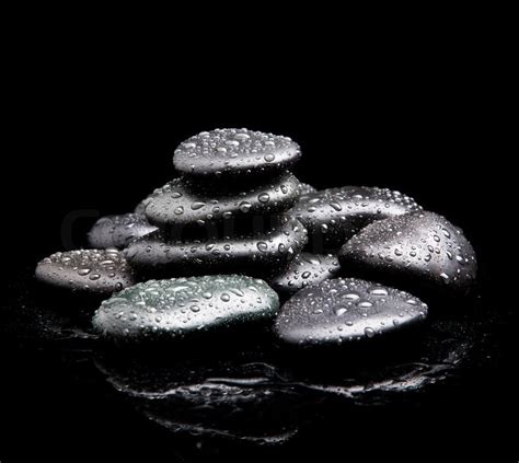 Black Shiny Zen Stones With Water Drops Over Black Background Stock