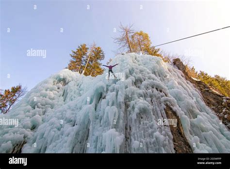 Female Ice Climber Hanging On A Rope And Changing The Place By Jumping