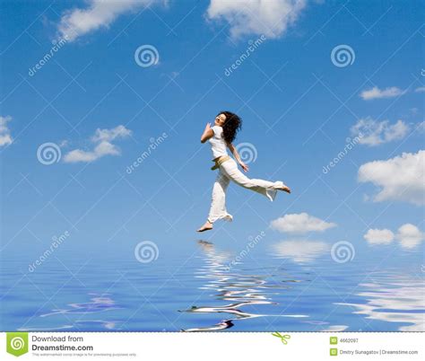 Happy Young Woman Jumping On The Water Royalty Free Stock