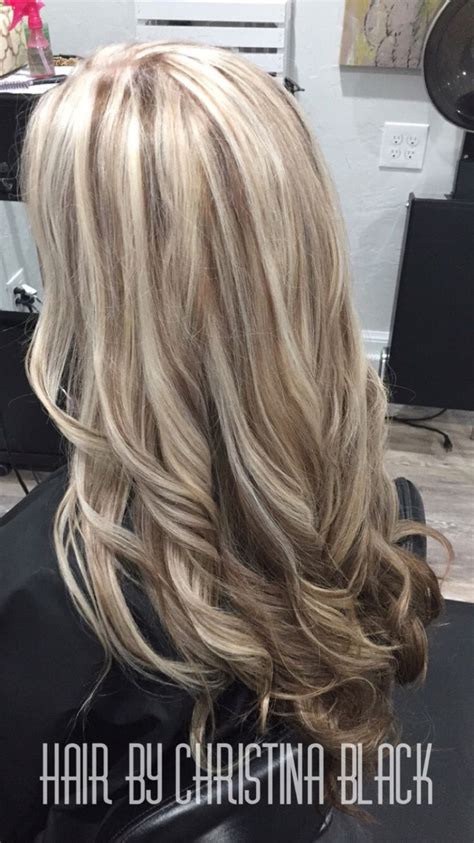 The artist has avoided creating a high contrast look by starting the balayage fade right at the roots. Ash blonde highlights with chocolate brown lowlights and ...