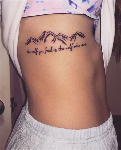 Popular spots for women's cross tattoos include: Mountain Tattoos / quote tattoos "the wolf you feed is the ...
