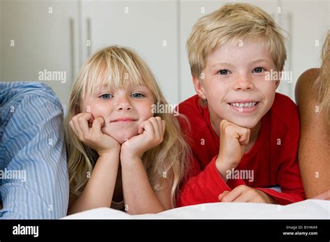 Portrait Of Children Lying On A Bed Stock Photo Alamy