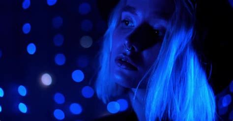 Millennial Enigmatic Pretty Girl Blond Hairstyle Near Glowing Neon Wall