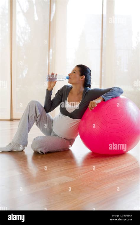 Pregnant Woman Drinking Water During Fitness Stock Photo Alamy