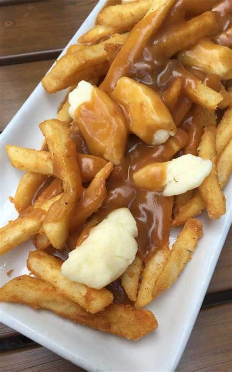 French fries and squeaky cheese curds get smothered in a dark guinness draught gravy for a poutine that would make any québécois proud. Traditional Canadian Poutine - Master of kitchen