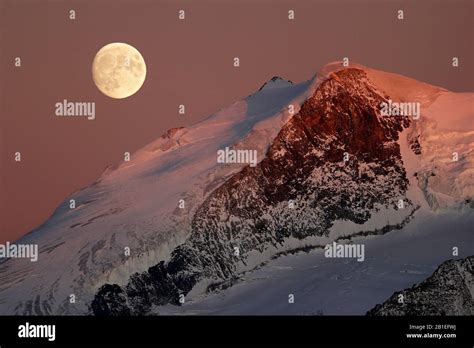 Full Moon Over The Valais Alps Switzerland Stock Photo Alamy